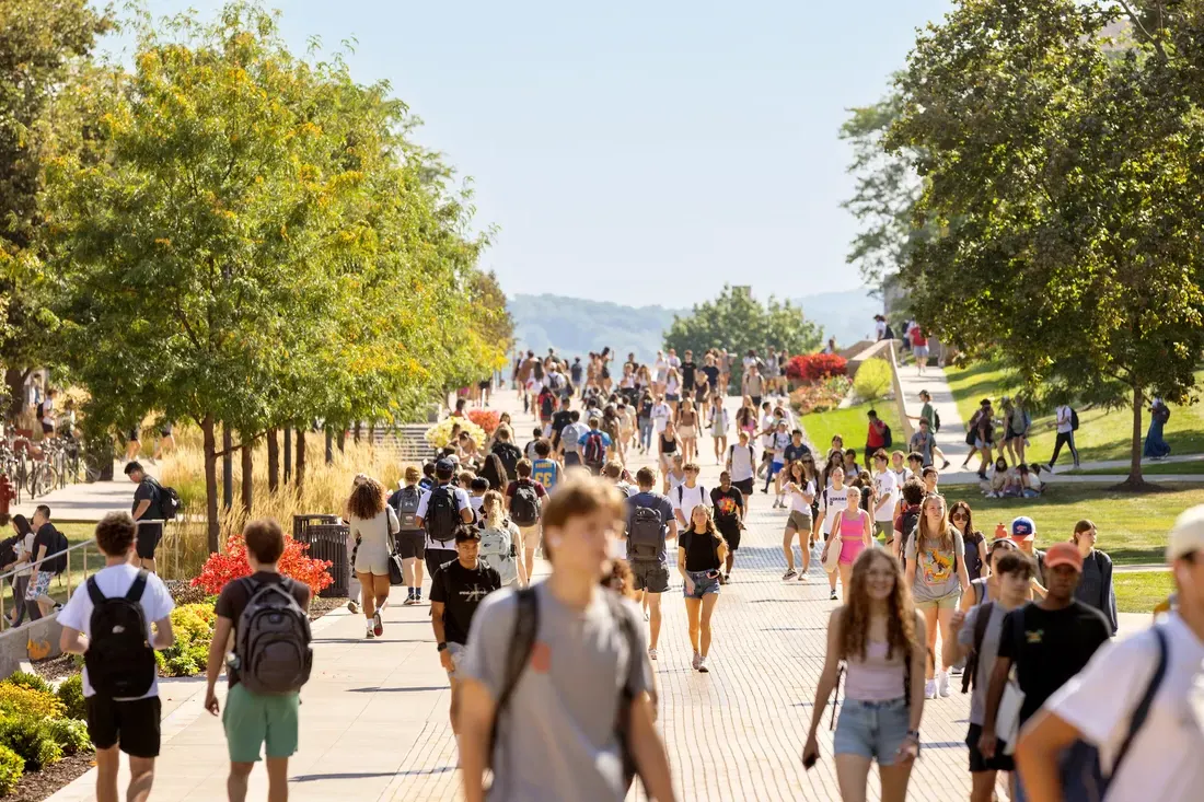 Students outdoors walking on campus.